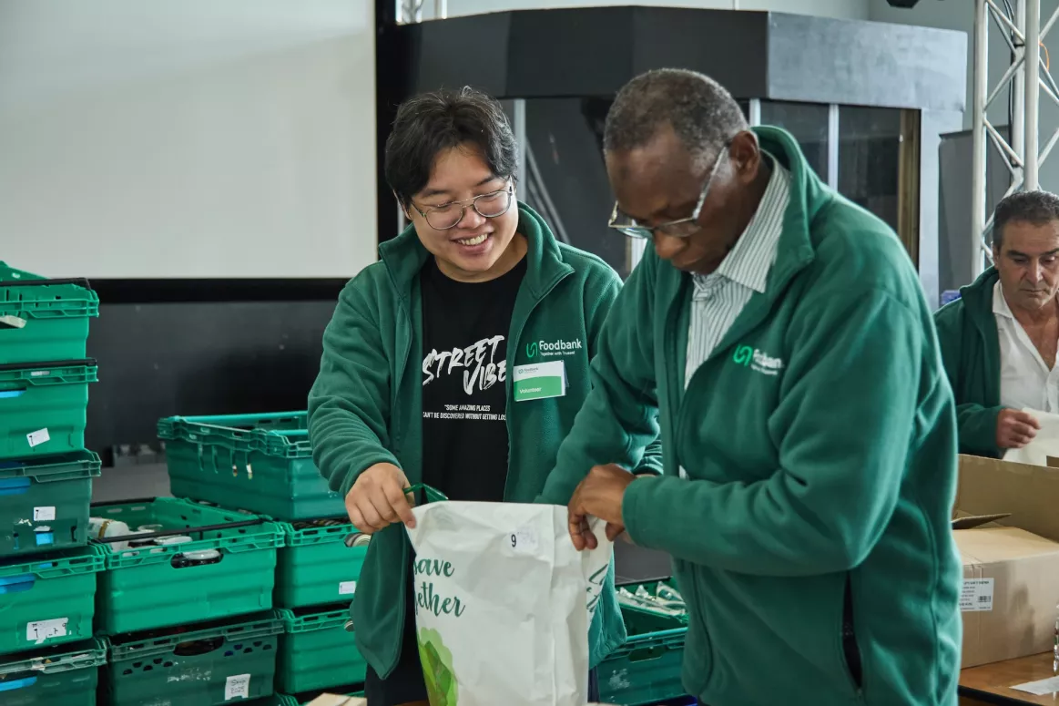 Two men packing bags of food at Bradford food bank