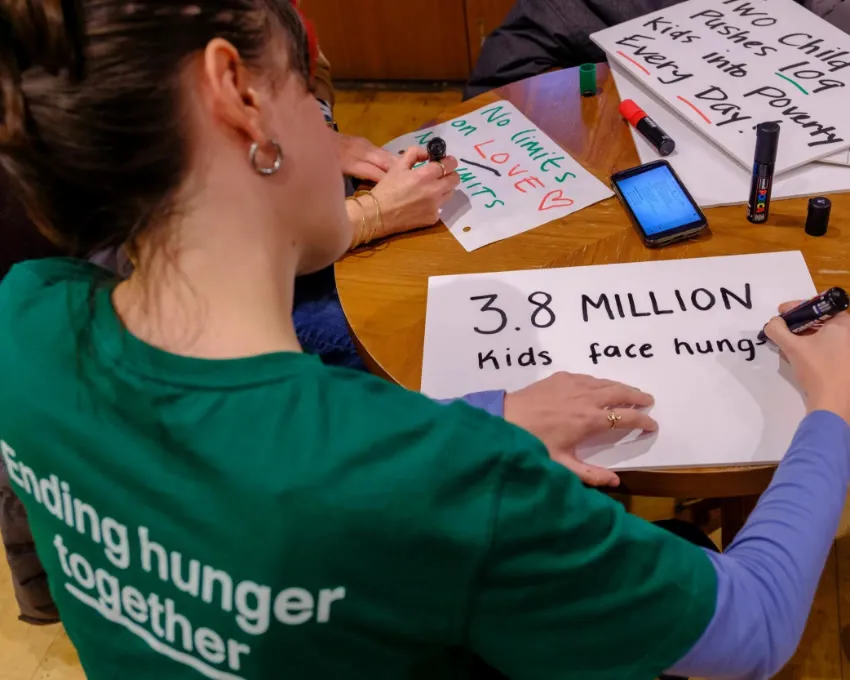 Woman writing protest sign